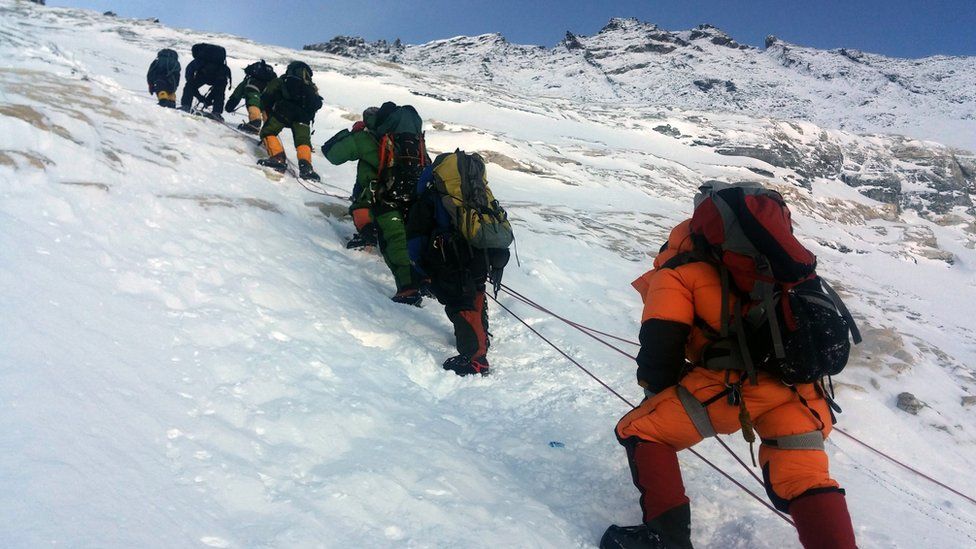In this photograph taken on May 9, 2016, mountaineers walk from Camp 3 to Camp 4, as they pushing for the summit of Mount Everest.