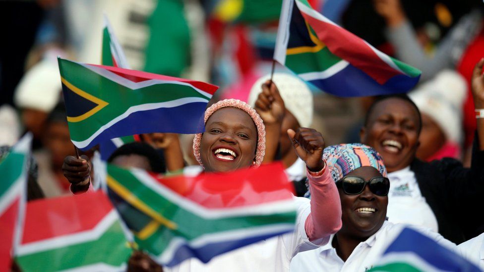 South Africans cheering and waving flags
