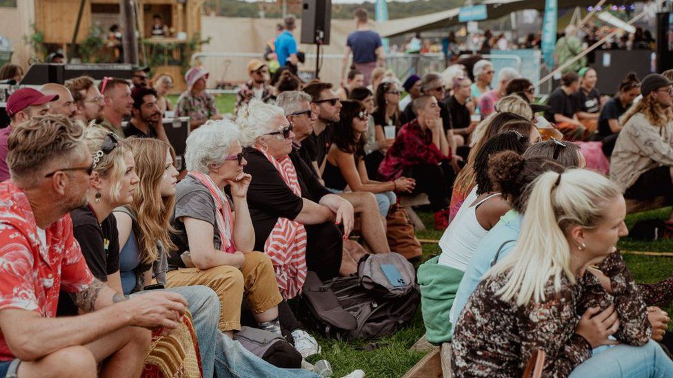 A crowd of people listening to a talk