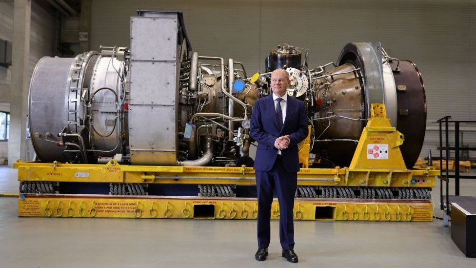 German Chancellor Olaf Scholz standing in front of gas turbine in Germany