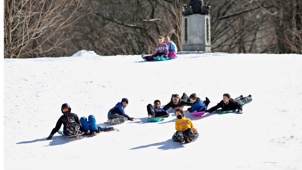 Children playing in the snow in Central Park