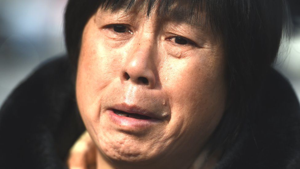 A relative of a passenger missing on Malaysia Airlines MH370, cries during a gathering of relatives outside the Lama Temple in Beijing on 8 March 2016.