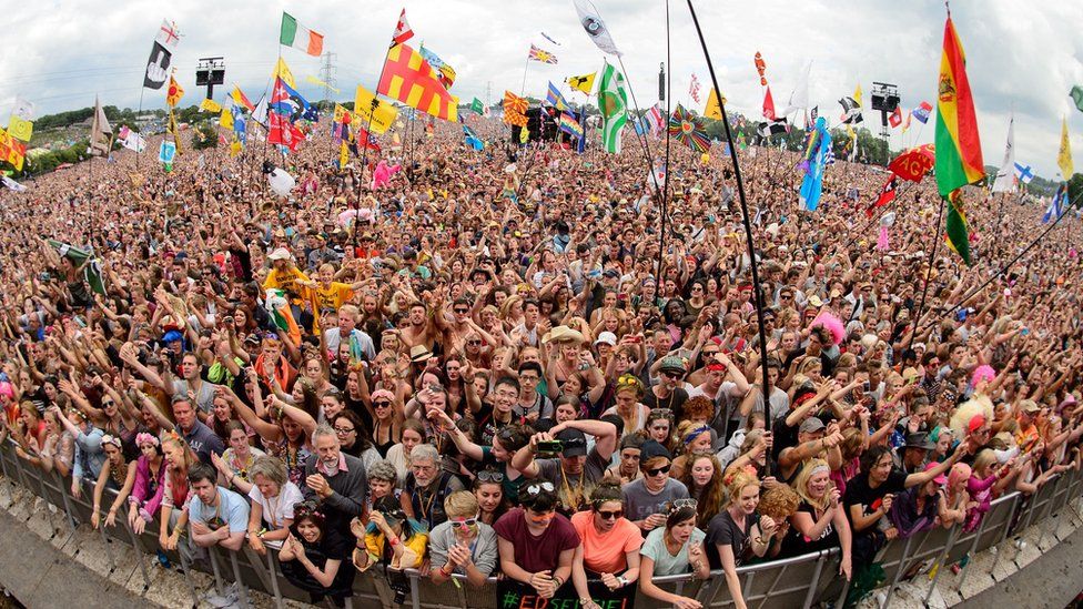 A wide shot of the crowd in front of the Pyramid stage at Glastonbury