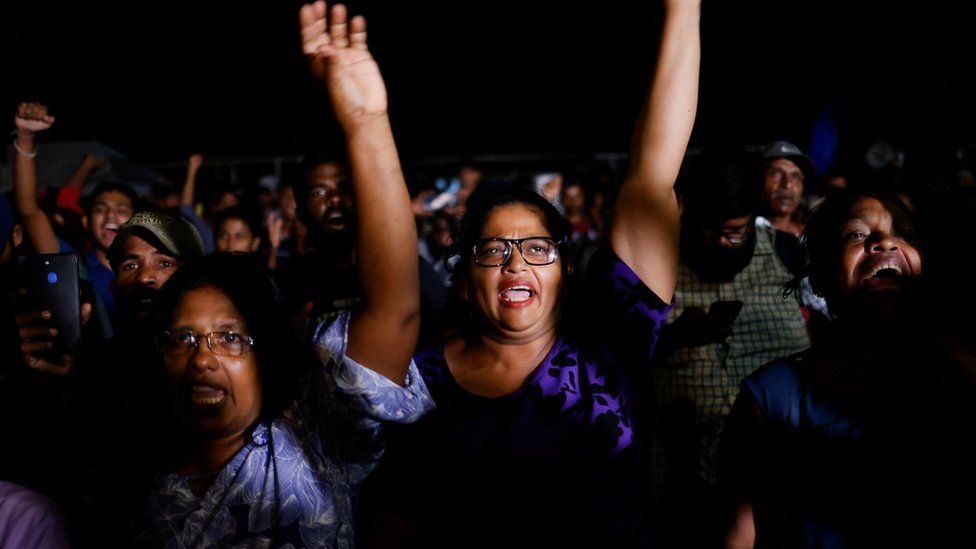 People dance as they celebrate the resignation of Sri Lanka's President Gotabaya Rajapaksa at a protest site