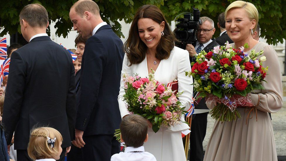 The duchess and Poland's first lady received flowers after a meeting at the presidential palace