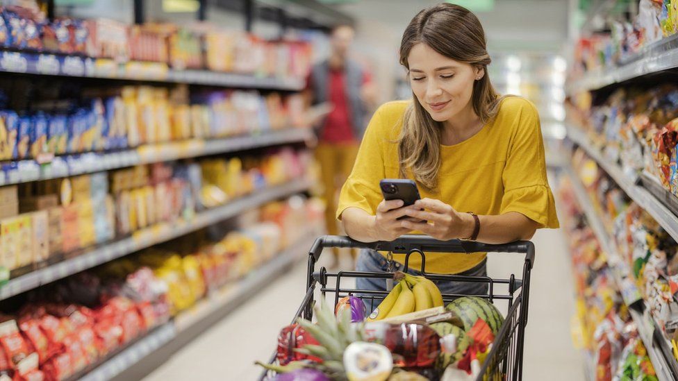 Stock image of a woman shopping in a supermarket