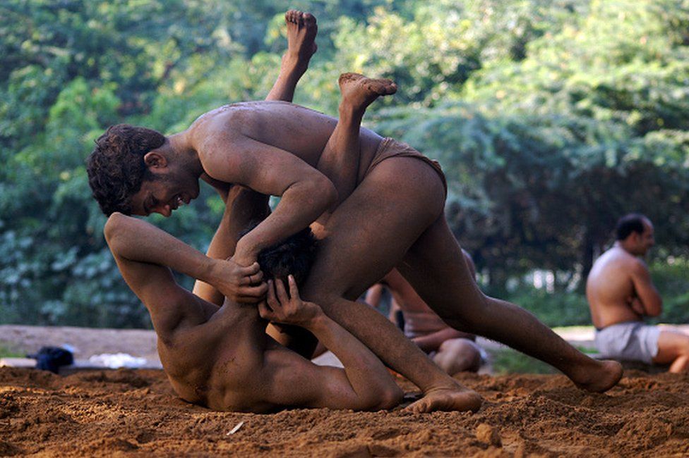 Indian wrestlers fight during a practice session, at an Akhara (wrestling) ground on the outskirts of New Delhi, 22 September 2007.
