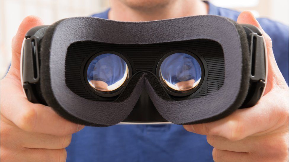 A man holding a VR headset