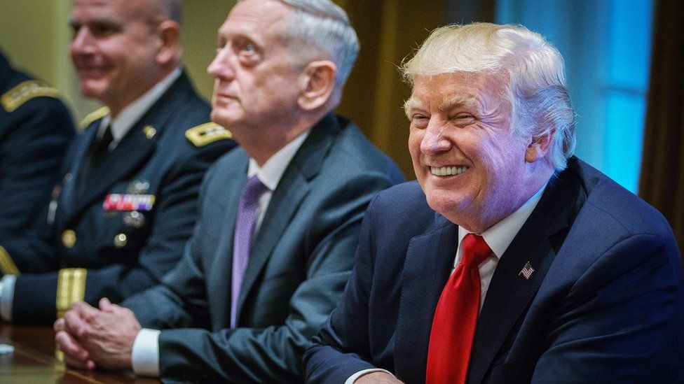 US President Donald Trump smiles as Defense Secretary James Mattis (C) looks on during a meeting with senior military leaders in the Cabinet Room of the White House on October 5, 2017