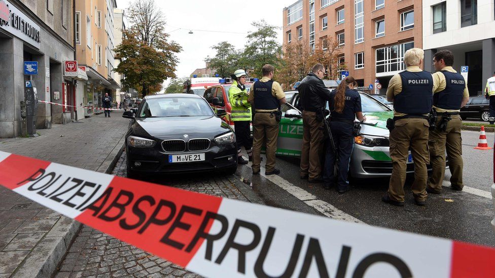 German police stands inside a security perimeter set after a man attacked passersby near Rosenheimer Platz in the southern German city of Munich on October 21, 2017.