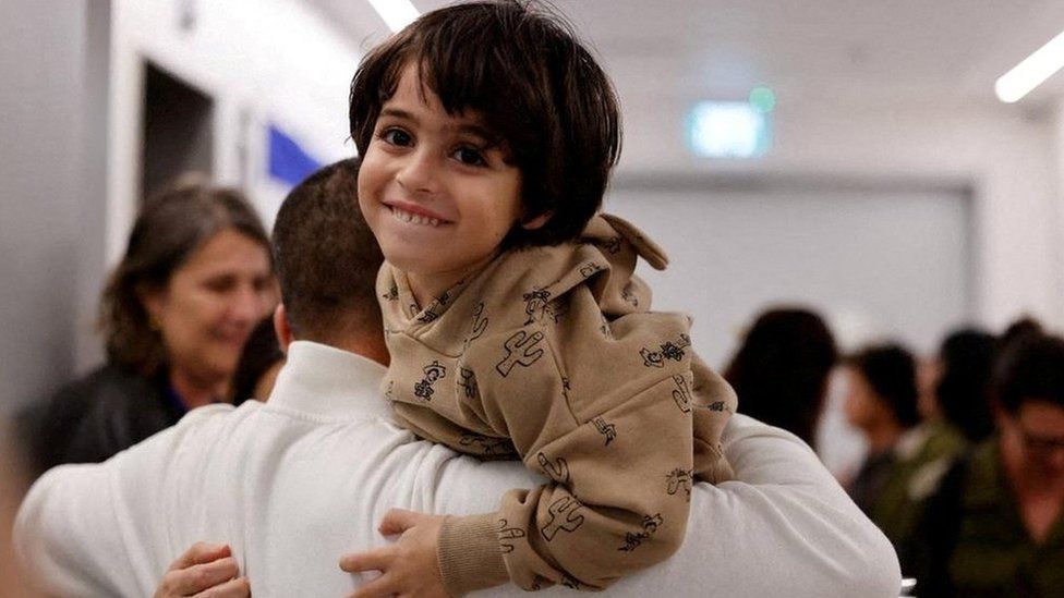 Oria Brodutch jumps onto his father Avihai Brodutch shortly after they were reunited in Israel on 26 November, following the release of Oria, his mother Hagar and his siblings Yuval and Ofri, at Schneider Children's Medical Center of Israel
