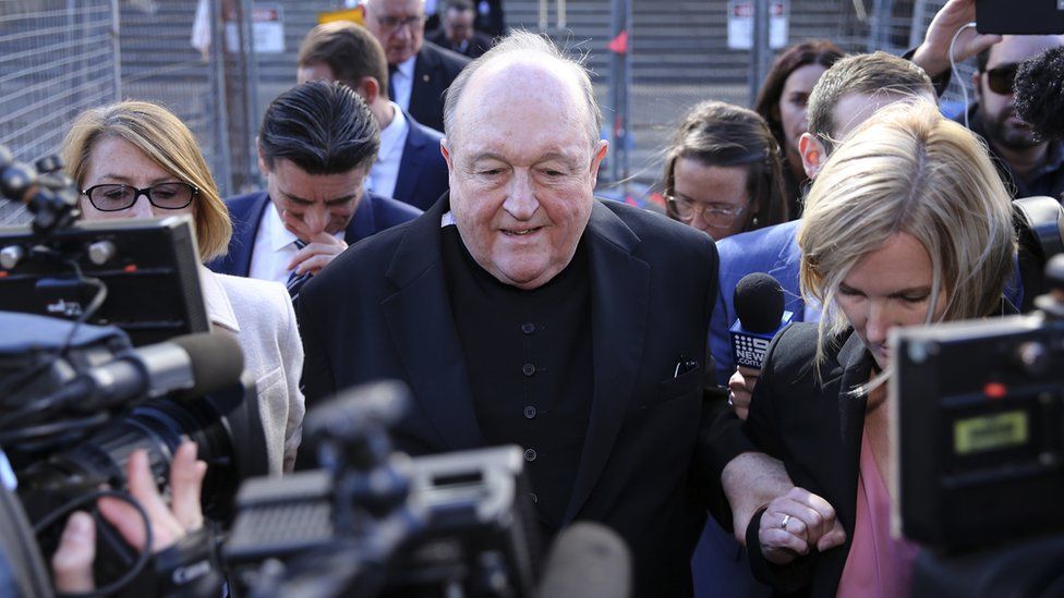 Archbishop Philip Wilson leaving court, surrounded by reporters