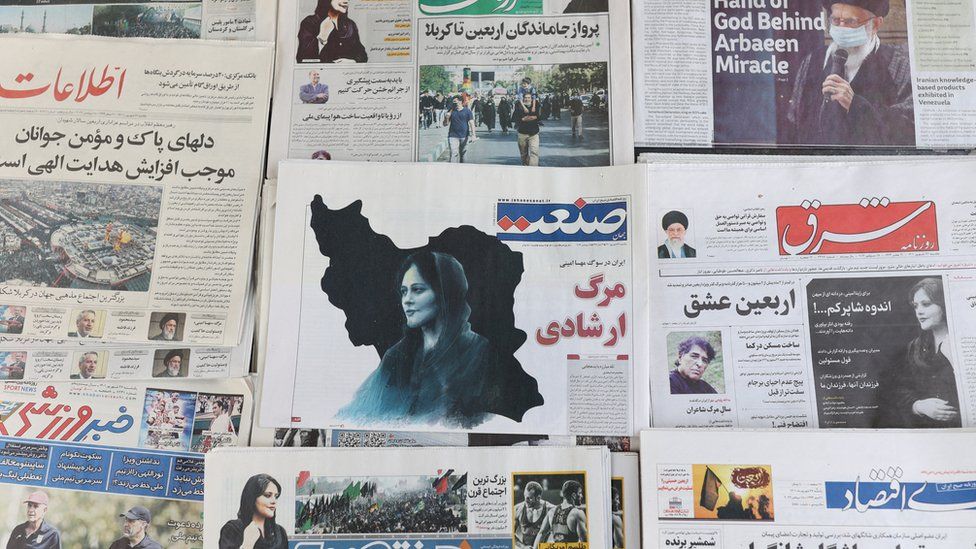 Iranian newspapers on sale in Tehran show photographs of Mahsa Amini on 18 September 2022