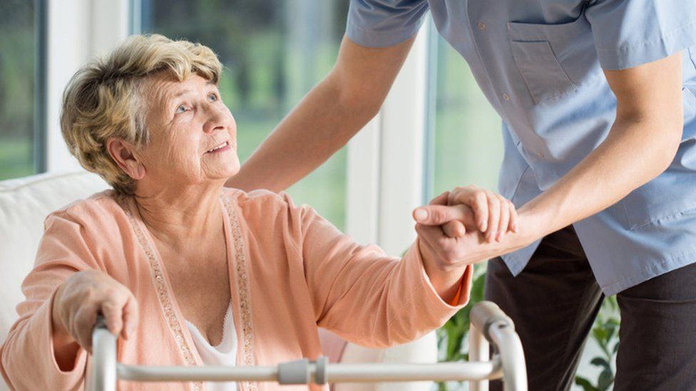 Elderly nursing home resident with carer