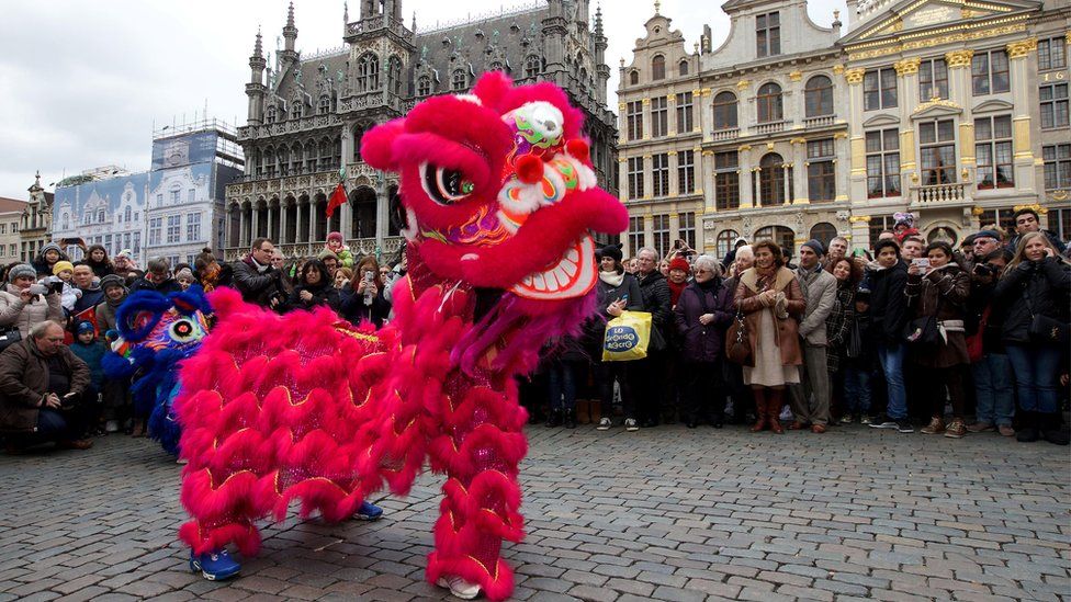 People look at the Chinese Lunar New Year celebrations parade for the beginning of the Year of the Monkey in Brussels