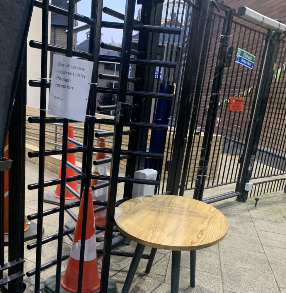 Turnstile with chair and a road works cone blocking it