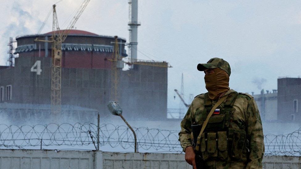 A Russian soldier stands guard near the Zaporizhzhia nuclear power plant on 4 August