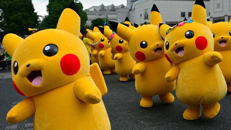 Dozens of Pikachu characters parade at the Landmark Plaza shopping mall in Yokohama