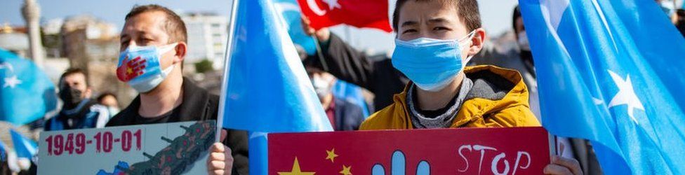 Members of the Muslim Uighur minority hold placards as they demonstrate to ask for news of their relatives and to express their concern about the ratification of an extradition treaty between China and Turkey at Uskudar square in Istanbul on February 26, 2021.