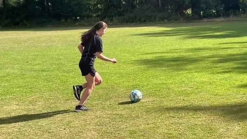 Lacey kicking a ball