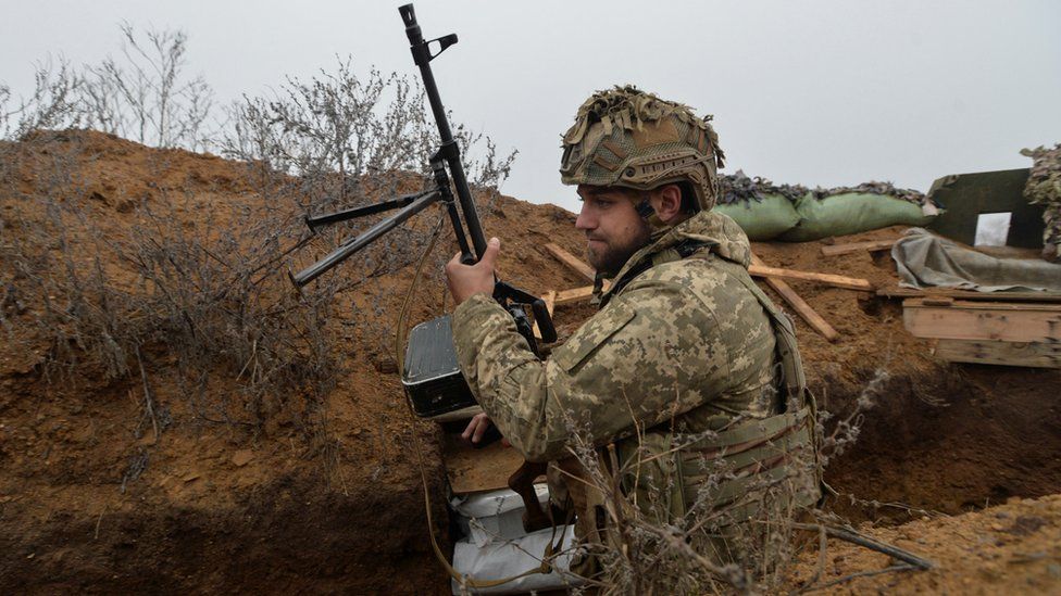 A Ukrainian service member is seen at a position on the front line near the town of New York (Novhorodske) in Donetsk region, Ukraine December 17, 2021