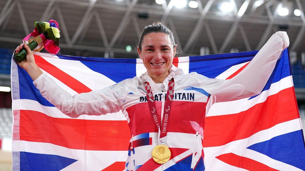 Sarah Storey with flag and medal