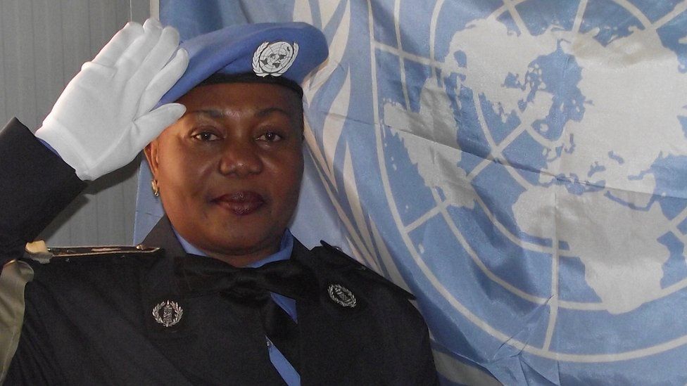 Josephine Ngale in front of UN flag