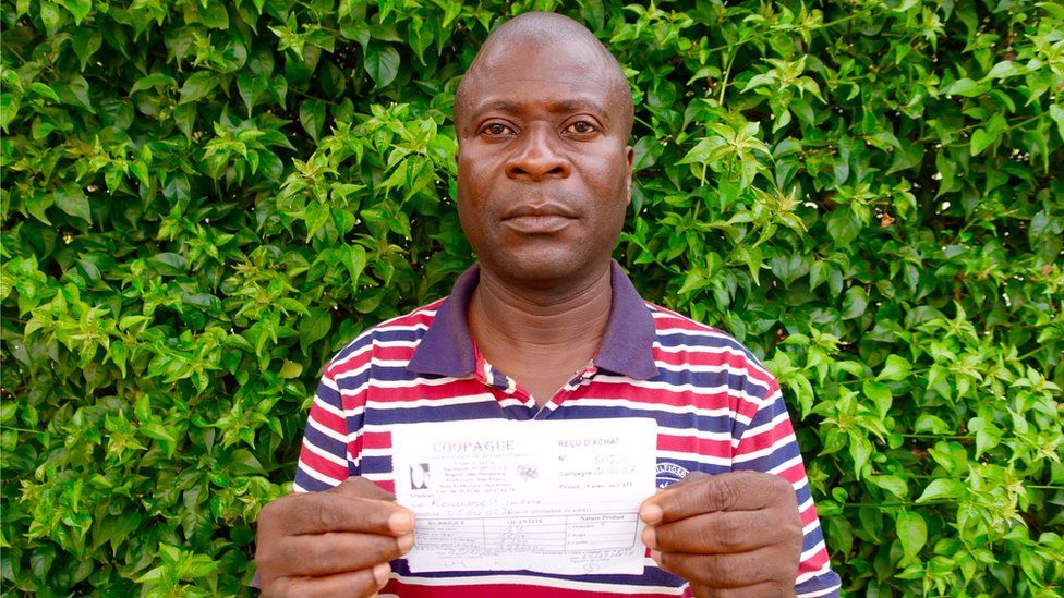 George Koffi Kouame with the receipt for the cocoa he delivered in October 2016