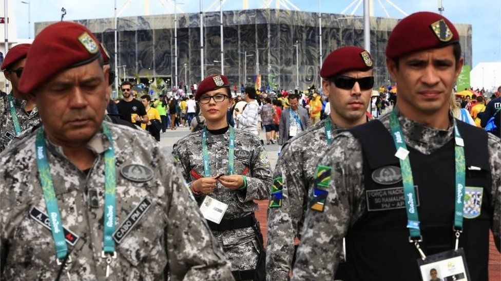 Brazilian soldiers among spectators inside the Barra Olympic Park with the Aquatic Center seen in background during the Rio 2016 Olympic Games in Rio de Janeiro, Brazil, 12 August 2016.