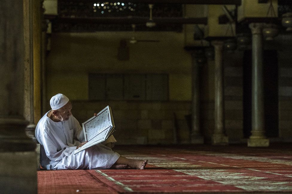 An elderly man reading the Koran at the al-Azhar mosque in Cairo