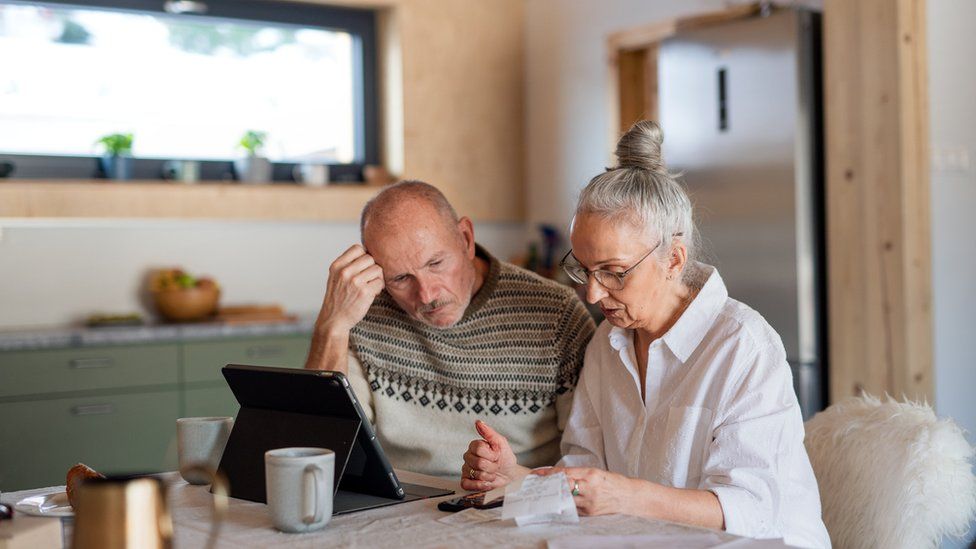 (stock image) man and a woman at a kitchen table