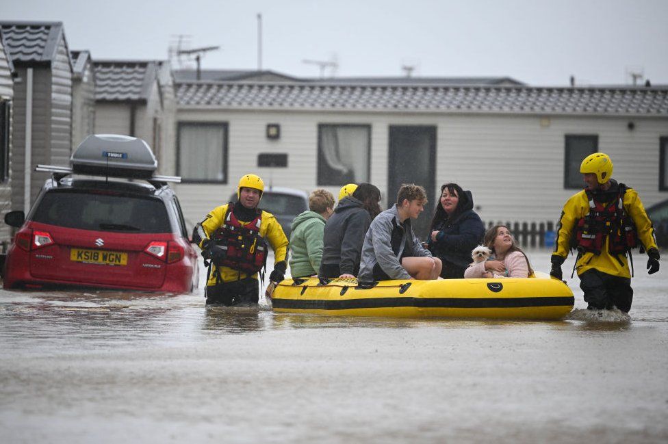 People are rescued from their holiday chalets by fire and rescue at Freshwater Beach Holiday Park, on November 02, 2023 in Burton Bradstock, Dorset.