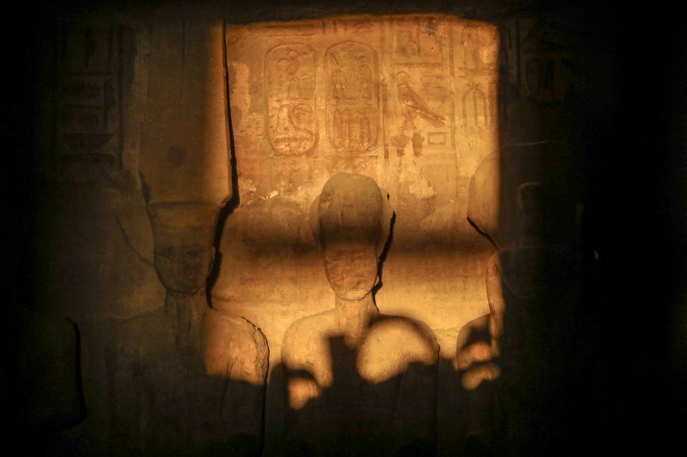 The sun illuminates the stone sculpture of Pharaoh Ramses II.