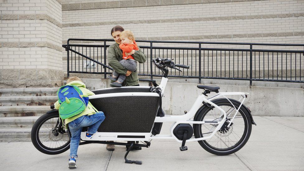 Woman with two children and an electric-cargo bike
