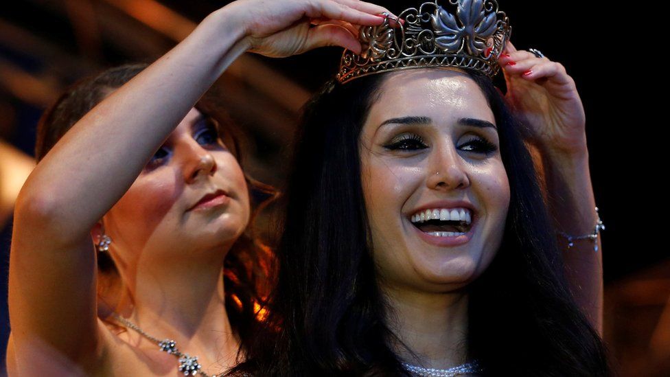 Syrian refugee Ninorta Bahno receives crown during ceremony for the new wine queen in Trier, Germany, August 3, 2016