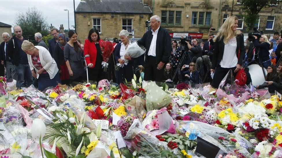 Gordon and Jean Leadbeater (centre), the parents of Labour MP Jo Cox, her sister sister Kim Leadbeater (right) join family members as they look at floral tributes left in Birstall, West Yorkshire