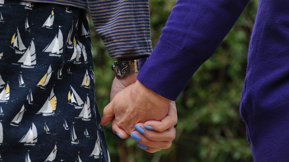 Penny and Lou holding hands