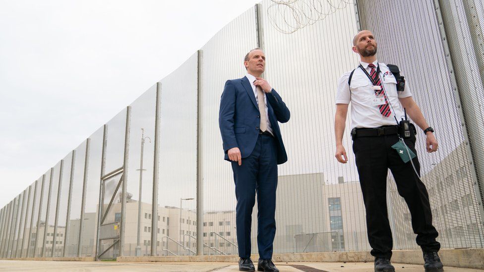 Deputy Prime Minister and Justice Secretary Dominic Raab with a prison officer at the opening of category C prison HMP Five Wells in Wellingborough