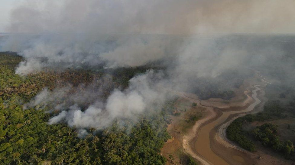 Smoke from a wildfire in the Amazon rainforest near a dry river in Amazonas state, Brazil, September, 2023.