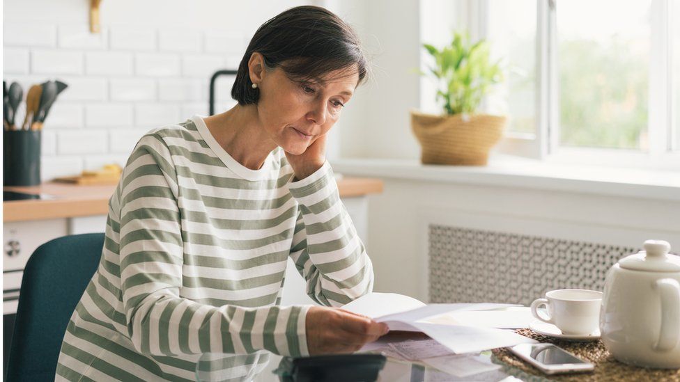 Woman looks at bill - stock shot