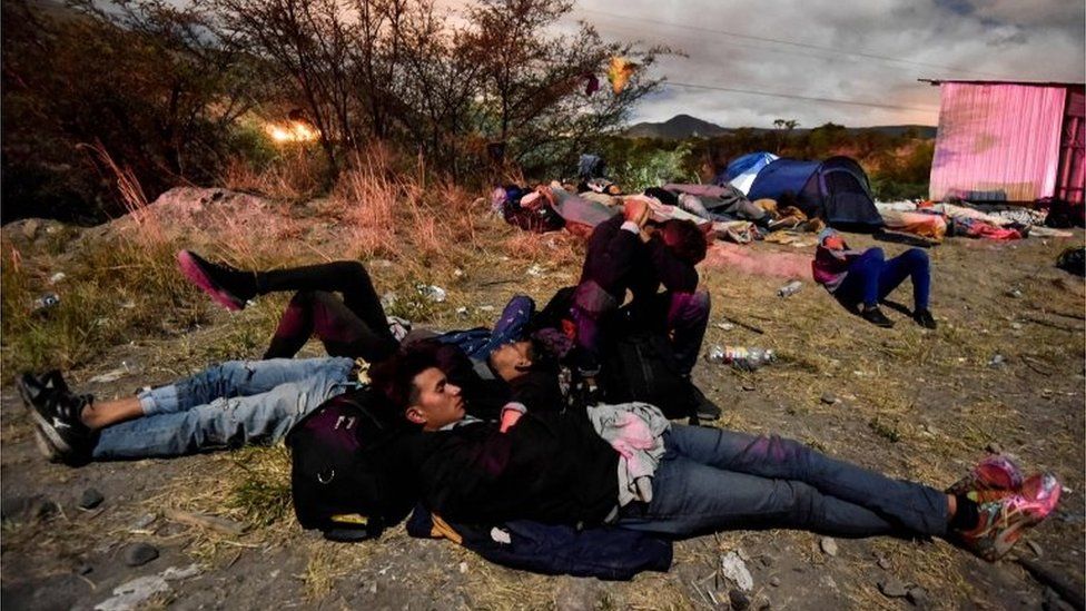 Venezuelan migrants on their way to Peru sleep along the Pan-American Highway between Tulcan and Ibarra in Ecuador