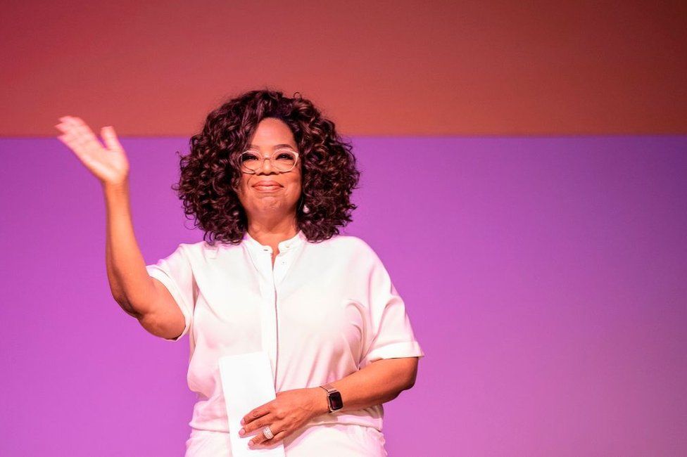 US TV personality Oprah Winfrey waves during an event to mark 100 years since the birth of Nelson Mandela, at the University of Johannesburg, Soweto Campus, in Johannesburg, South Africa - 29 November 2018
