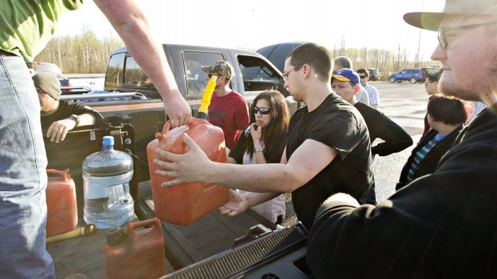 Fuel is handed out to evacuees, 4 May