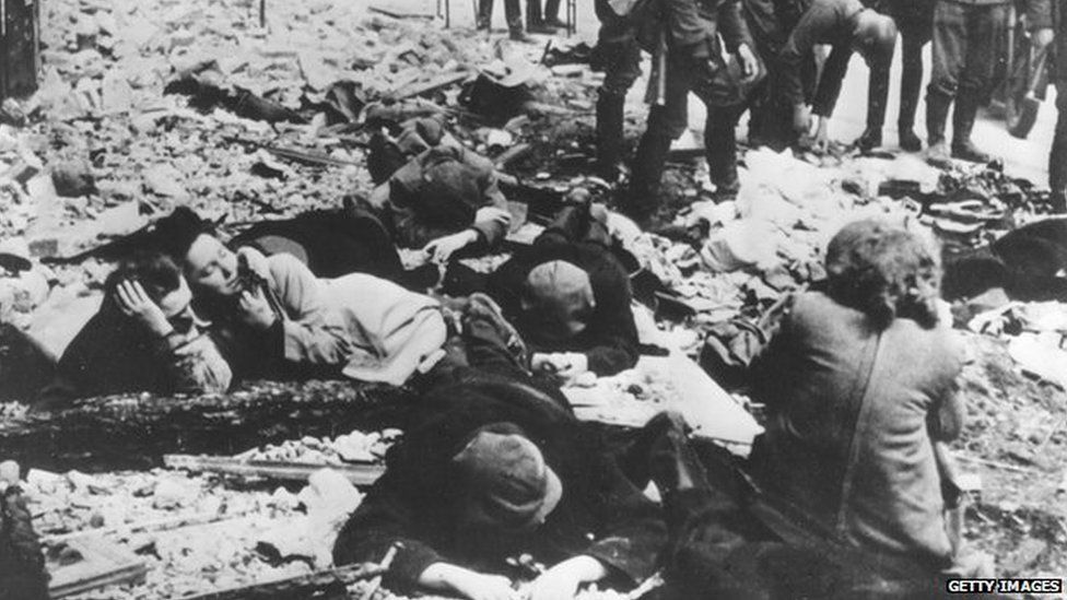 A Nazi SS-man inspects a group of Jewish workers in a ghetto in Poland during World War II