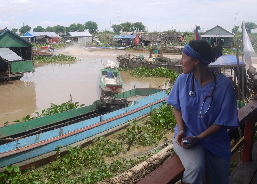 A doctor sits looking across at the floating clinic