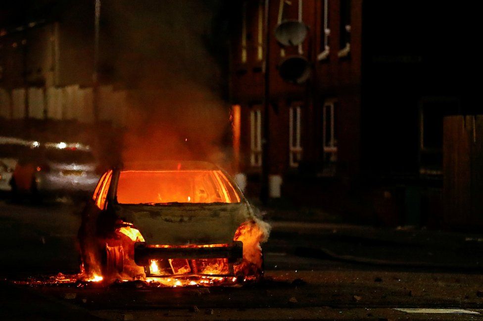 A car on fire on a street in Belfast