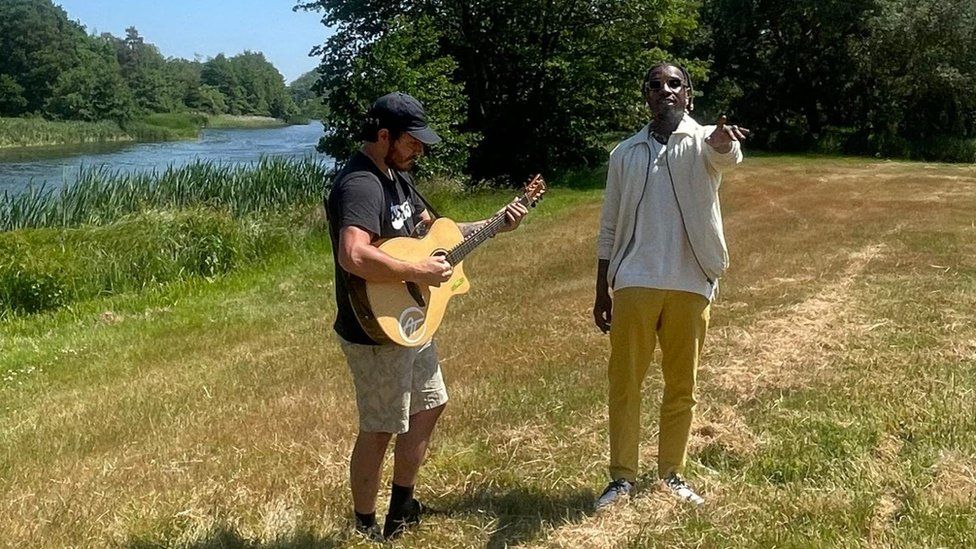 Native James with a guitarist at Henham Park, Suffolk