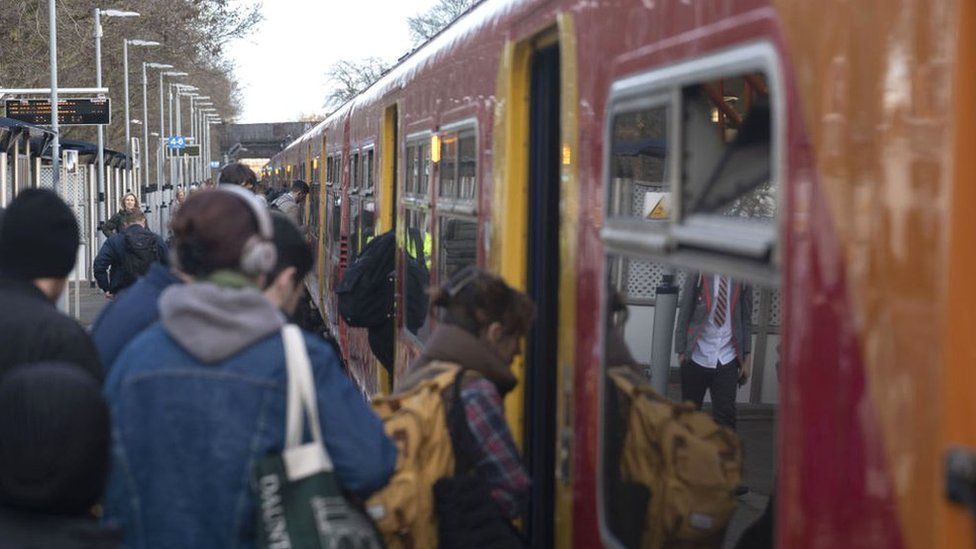 Passengers boarding a busy train