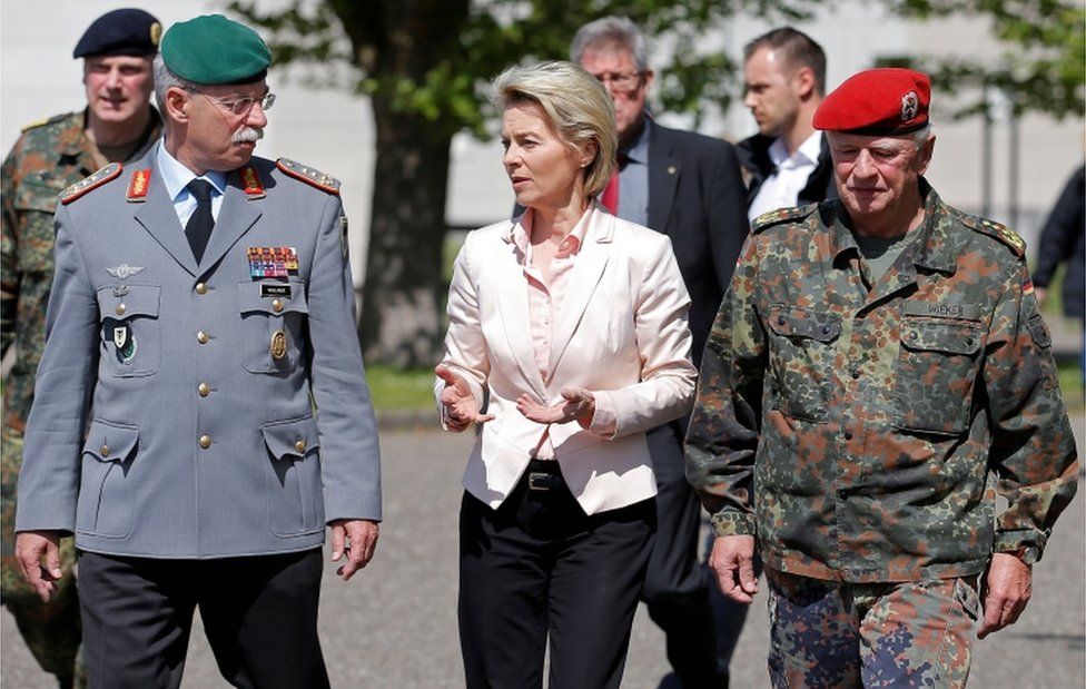 German Defence Minister Ursula von der Leyen (C) walks with General Joerg Vollmer, General Inspector of the German Land Army (L), and General Volker Wieker, Inspector General of Germany' Armed Forces in Bundeswehr, during her visit to the 291st fighter squadron in Illkirch on 3 May, 2017.