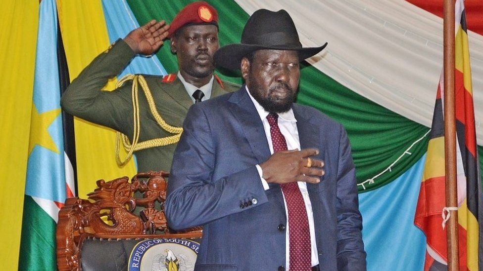 South Sudan"s President Salva Kiir (C) stands for South Sudan"s national anthem before signing a peace agreement in the capital Juba, on August 26, 2015.